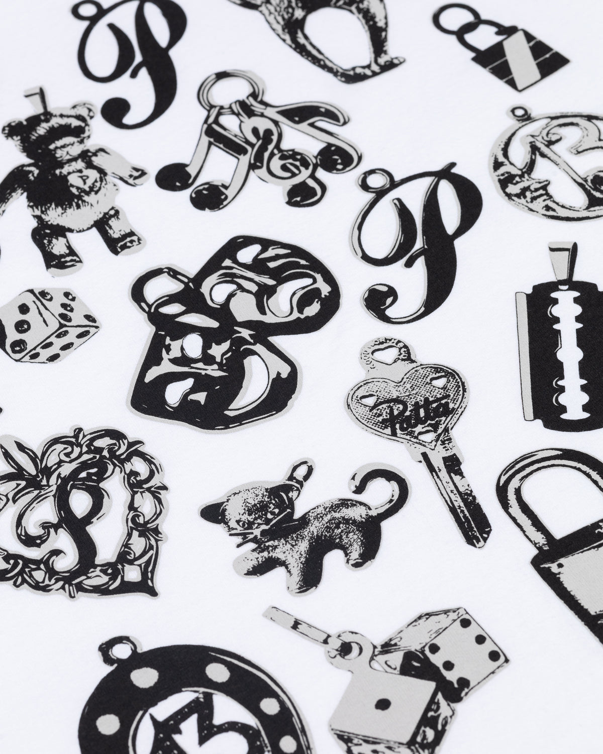 Close-up of black charms graphic print on the white Patta Kids Charm T-Shirt.